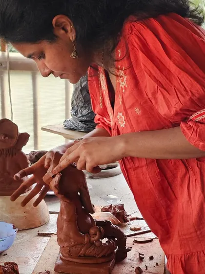 A student fully immersed in the process of sculpting her Ganesha during our weekend workshop.