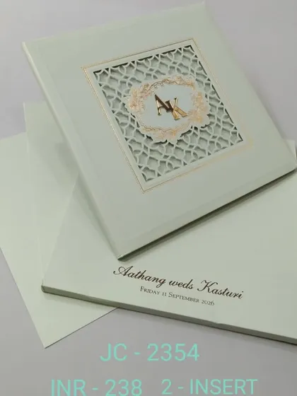 This sage green invitation features a laser-cut lattice window with a custom monogram. The design is clean, modern, and elegant.