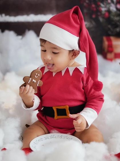 Santa's little elf enjoying a gingerbread cookie. This is a throwback to one of my previous Christmas mini sessions, which are always full of fun and sweet treats.