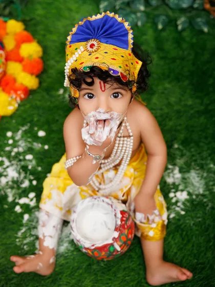 Getting messy with the makhan! This little Krishna is having the time of his life during our fun Janmashtami shoot.