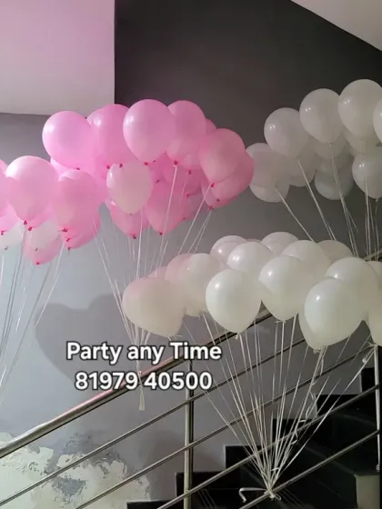 Pink and white helium balloon bunches ready for delivery.