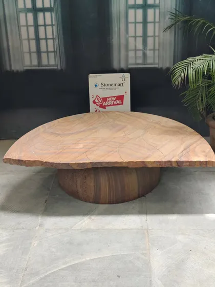 This modern stone seating bench features a smooth, curved top and a solid, rounded base. It's a contemporary design that works equally well in a luxury interior or an extraordinary backyard garden.