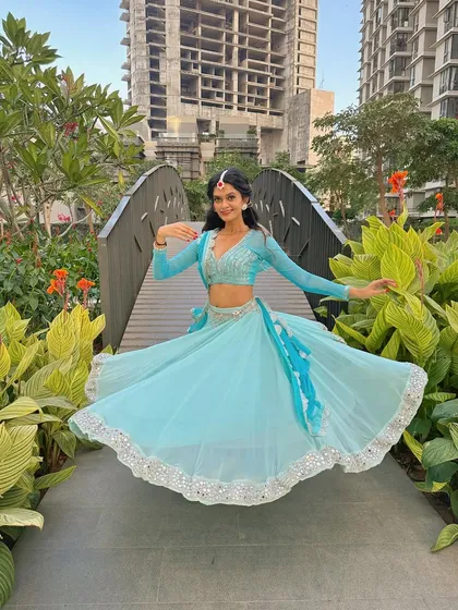 A moment of stillness in my semi-classical attire. The costume, with its flowing skirt and traditional details, is an integral part of the performance.
