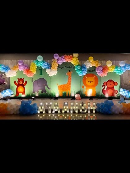 A wide-format jungle theme backdrop with cute cartoon animals and a colorful balloon border, perfect for a large party space.
