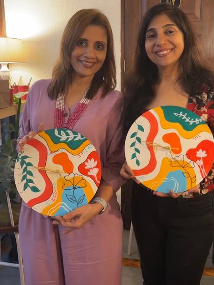 Two participants showing off their colorful and unique boho clocks. My workshops are perfect for making any celebration, like a kitty party, more creative and memorable.