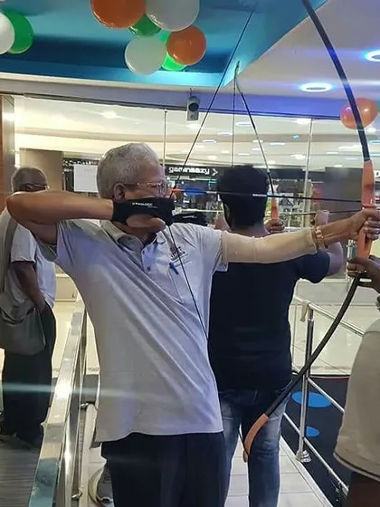 A senior participant shows excellent form as he takes aim. It is inspiring to see people of all ages embrace the challenge of archery.