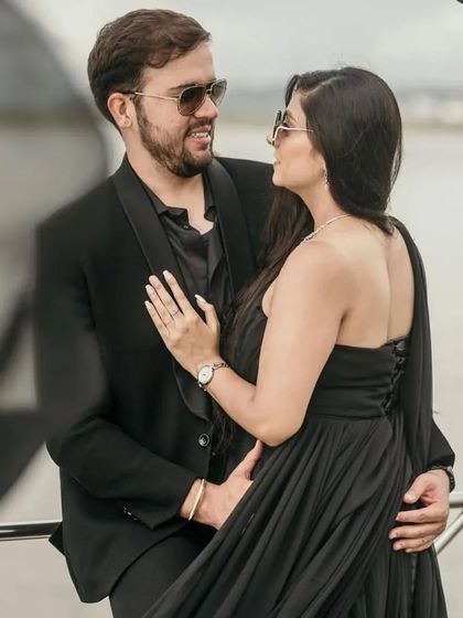 An intimate close-up from the yacht photoshoot, showing the elegant one-shoulder design of our black trail gown.