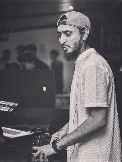 A candid black and white photo of me at work, focused on the mixer. These are the quiet moments of concentration amidst the noise.