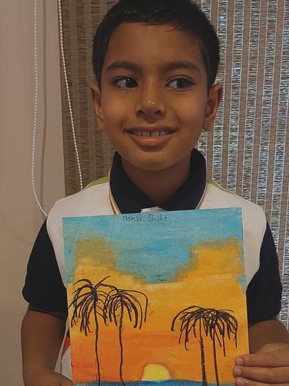 This student's beach sunset scene captures the warm glow of the sun and the cool tones of the water perfectly.