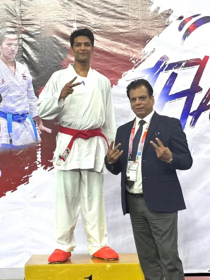 Standing with my son Pranay on the winner's podium at the Thailand Open. Seeing him achieve success on the international stage is a validation of our shared journey in karate.