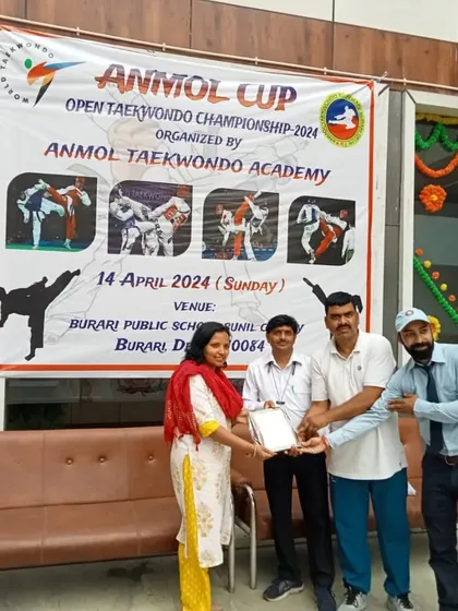 Presenting an award during the Anmol Cup ceremony. It is an honor to recognize the hard work and dedication of the participants and supporters.