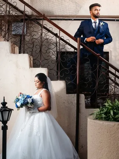 A portrait that uses the lines of a staircase to create a strong, dynamic composition. Placing the bride and groom on different levels adds depth and visual interest to the shot.
