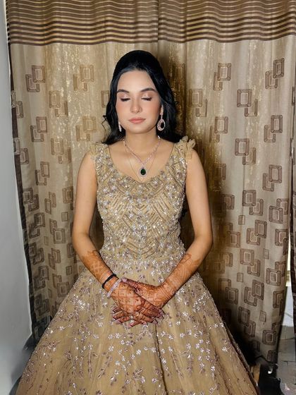 A serene shot with eyes closed, highlighting the shimmery, soft-toned eyeshadow and flawless skin.