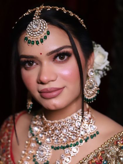 A modern royal bride look with a clean hairstyle and glowing skin. This demonstrates a different style of bridal makeup that is also in high demand.