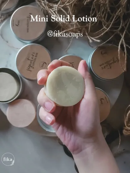 A close-up of my mini solid lotion bar. These are ethically made and packaged in reusable tins, allowing you to treat your skin while being kind to the planet.