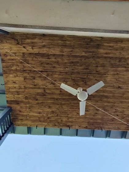 A close-up of a unique burnt-finish bamboo ceiling, adding a rustic and textured look to the underside of the pergola roof.