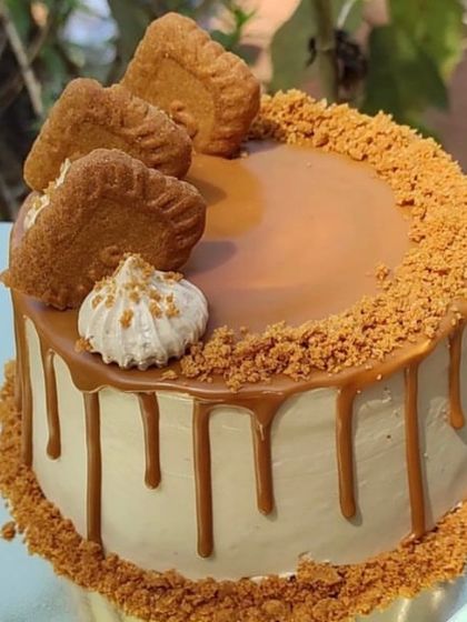 A beautiful Lotus Biscoff cake with a caramel drip and cookie crumble topping.