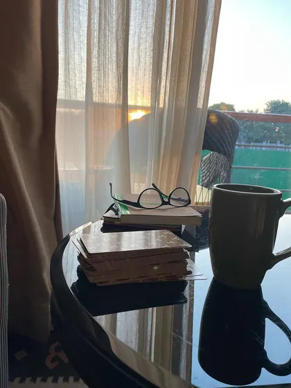 This is my perfect evening: a cup of chai, my tarot cards, a good book, and the sunset. This quiet, reflective time is essential for staying connected to my intuition and is a practice I encourage all my students to adopt.