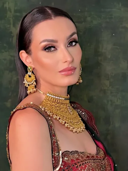 A close-up of the final look. The makeup is sophisticated and elegant, perfect for a high-end jewelry campaign.