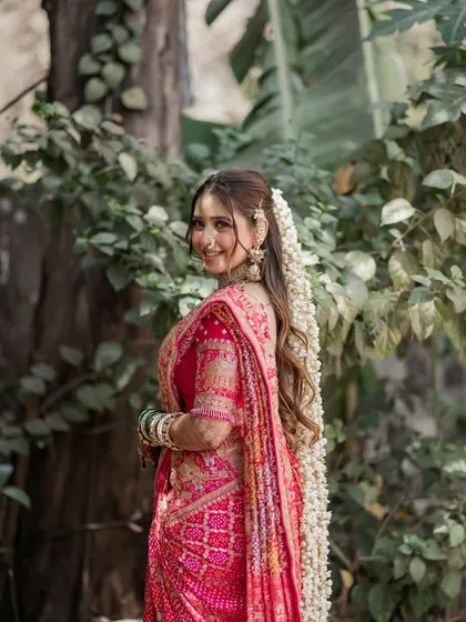A happy bride in a beautiful outdoor setting. Her natural, glowing makeup look is perfect for the daytime lighting, ensuring she looks fresh and radiant throughout the festivities.