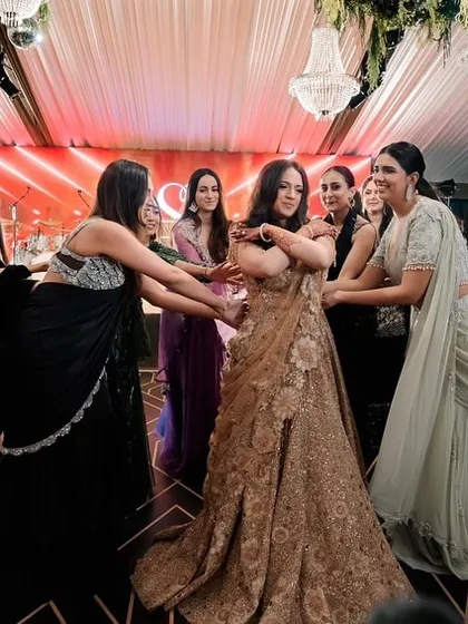 The bride and her bridesmaids in a candid, joyful moment during their performance.