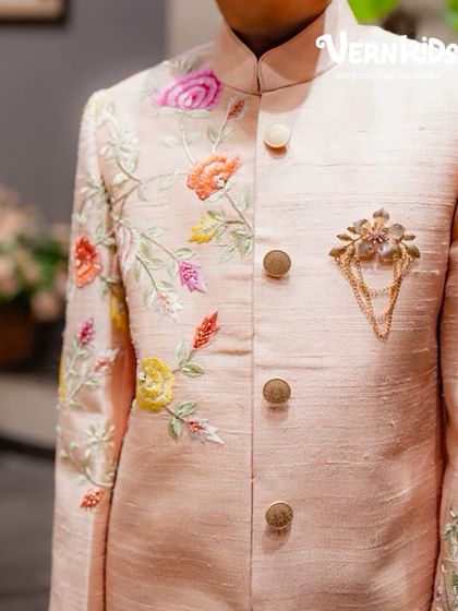 A detailed shot of the hand embroidery and brooch on our peach floral sherwani. Every element is carefully chosen to create a look of pure elegance.