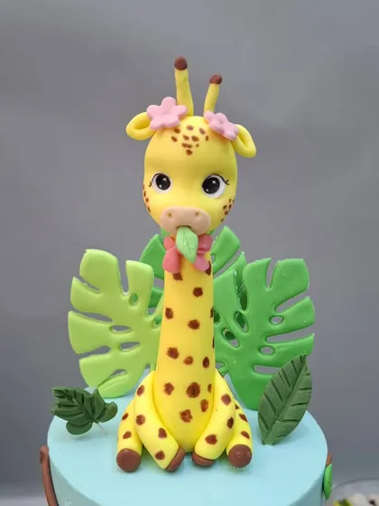 The giraffe topper, surrounded by fondant leaves.