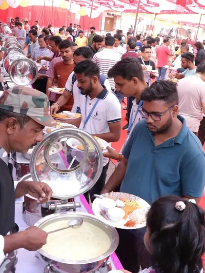 Our server helping a guest with a serving of a traditional curry. We take pride in offering attentive service to everyone at the event.