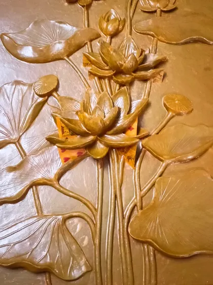 An alternate finish for the lotus mural, this version is finished with a metallic gold paint. This shows how the same sculpted piece can be customized to create a different mood, in this case, one of warmth and grandeur.
