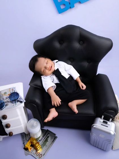 A funny and adorable shot of the Boss Baby mid-yawn, looking like he's laughing about a successful deal.