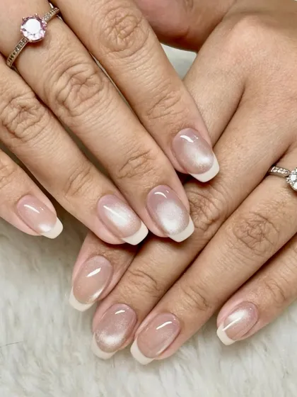 Quiet luxury, loud confidence. This is a perfect example of a glazed donut or chrome finish on a classic French manicure, giving it a modern and trendy update.