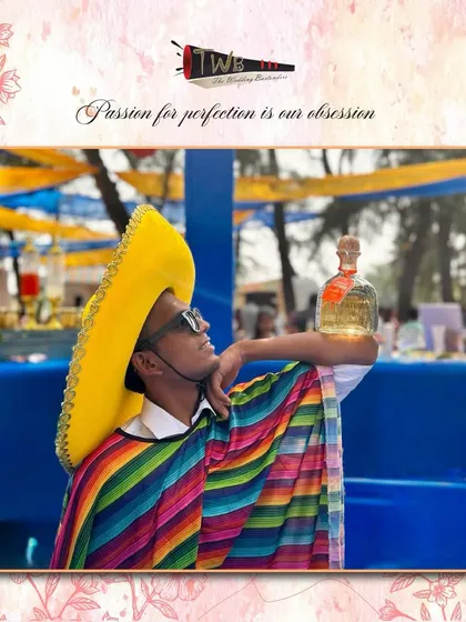 A bartender in a festive sombrero and poncho for a themed event in Goa, showing how we embrace the spirit of any party.