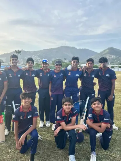 The team in their primary kits, posing for a photo against the Trinidad landscape.
