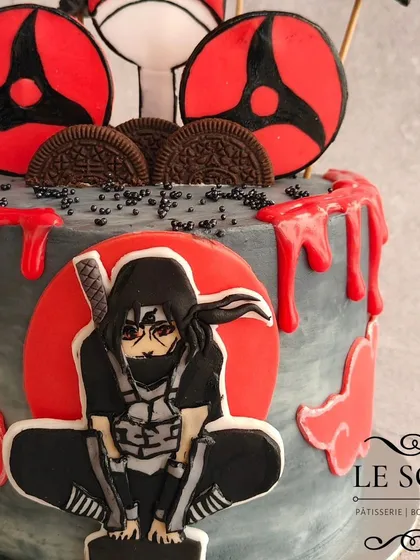 For all the anime fans, here's an Itachi Uchiha cake that was so much fun to design. This Milk & Cookies cake features a 2D fondant Itachi, his Sharingan, and a dramatic red and grey buttercream finish with a blood-drip effect.