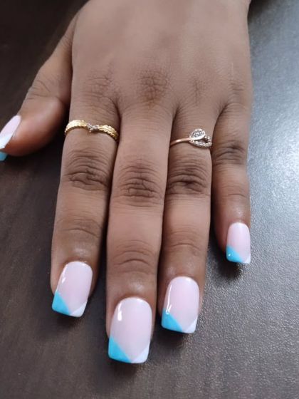 A modern, geometric take on the French manicure. I used a soft blue for these angular tips on square-shaped nails, creating a fresh and stylish look.
