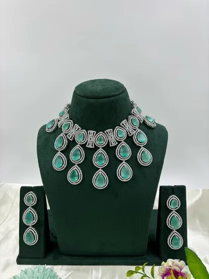The teardrop necklace with mint-green stones.