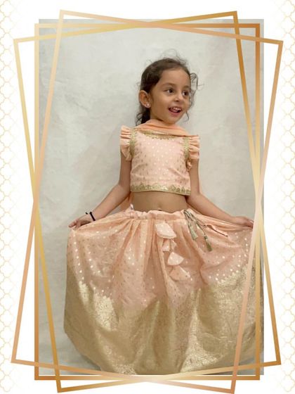 A full shot of the happy client in her periwinkle lehenga, showing how easy it is to move and sit in.