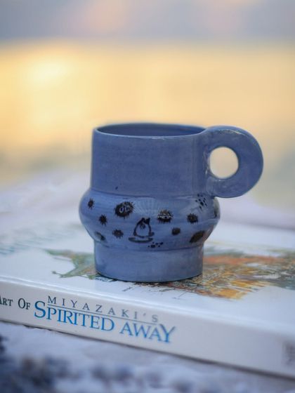 For the love of Ghibli, this mug is for you. I created this unique periwinkle blue clay by adding cobalt and iron oxide, then hand-painted my favorite soot sprites. This piece is a perfect example of the custom, whimsical commissions I love to create.