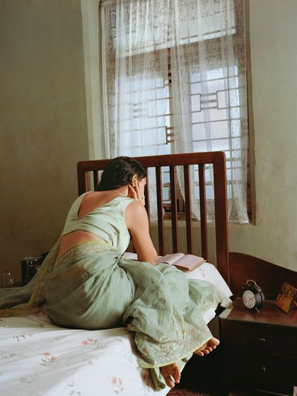 The same character in her bedroom, reading a book. These quiet, narrative scenes help build a complete world for the campaign, making the clothing feel lived-in.