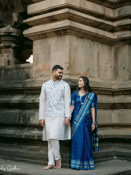 Standing before an ancient temple, Ankush and Aishwarya hold hands. This portrait balances the grandeur of the location with the simple, powerful connection between the couple.