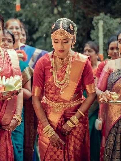 The elegance of a South Indian bride during her wedding ceremony, surrounded by family. We focus on capturing the rich traditions, vibrant colors, and intricate details of cultural weddings.