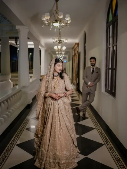 An artistic shot in a classic checkered hallway, with the bride in the foreground, creating a sense of depth and story.