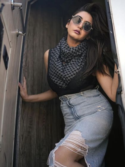 A casual portrait with a focus on personal style. The use of a scarf and denim creates a look that is both fashionable and accessible.