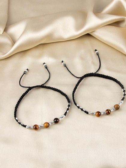 A pair of adjustable anklets with tiger's eye beads.