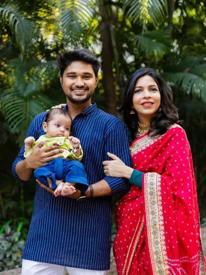 The first official family portrait. This photo was taken during a naming ceremony, capturing the proud parents with their newborn against a beautiful, natural backdrop.