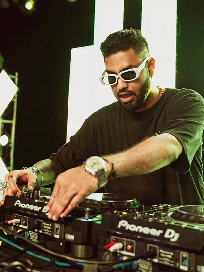 In the zone. This is where the magic happens, behind the decks, focused on the mix. Every track is chosen to build the energy and create a seamless journey for the dancefloor.