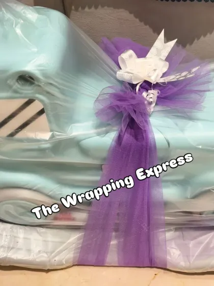 Even large gifts like this baby rocking car get a special touch with decorative wrapping.
