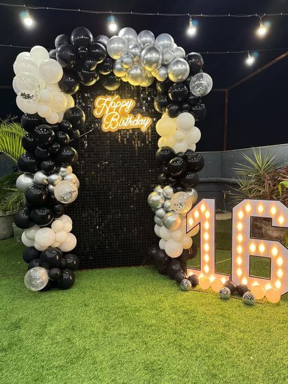 A view of the 16th birthday sequin backdrop without the cake plinth. This highlights the clean lines of the balloon arch and the impressive light-up marquee numbers, perfect for a stylish teen party.