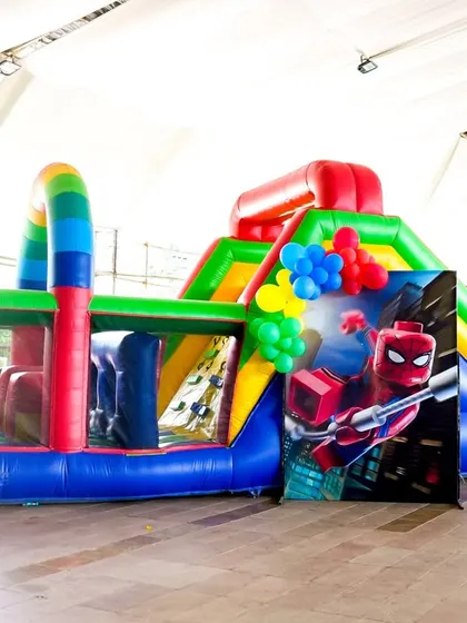 Our large inflatable obstacle course decorated with a Spider-Man theme, showing how we can customize rentals to fit your party's hero.