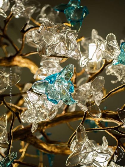 This enchanting chandelier is a bouquet of light, composed of dozens of hand-blown glass flowers in clear and soft blue hues. The intricate design creates a magical, garden-like atmosphere, perfect for a romantic bedroom or elegant dining space.